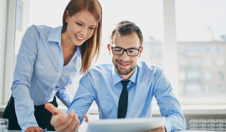 Frau und Mann schauen gemeinsam auf einen Bildschirm